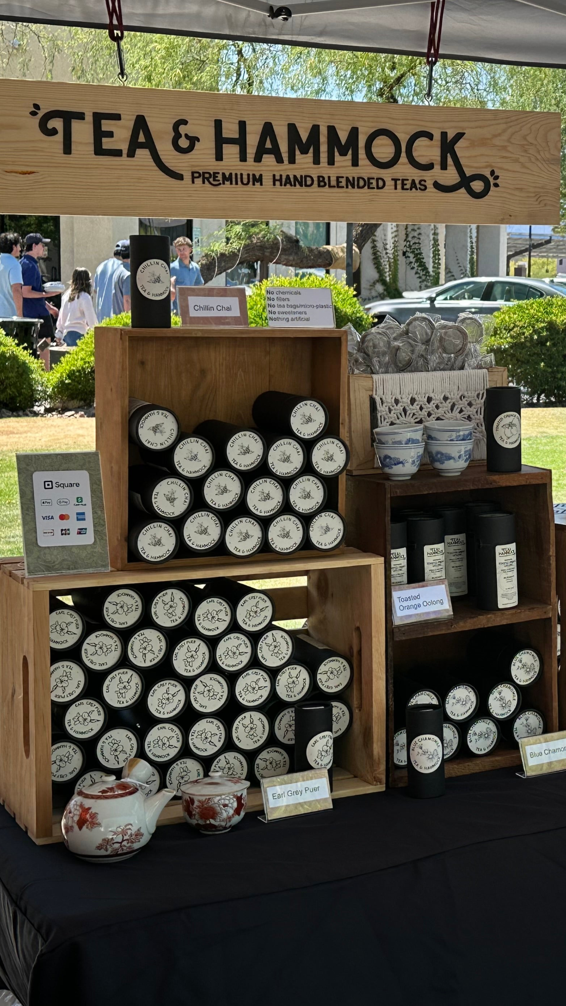Loose leaf Tea product display at an outdoor event under a tent.