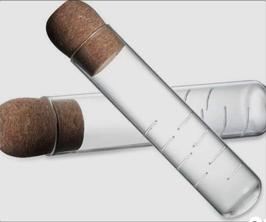 Two glass vials with cork stoppers on a white background.