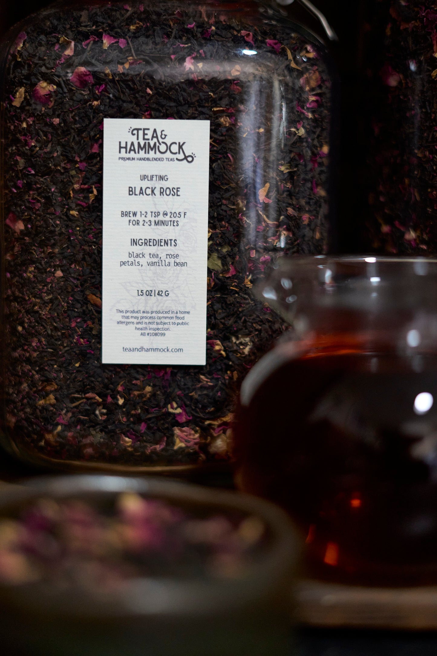 Tea package with a label and a glass of tea in the foreground