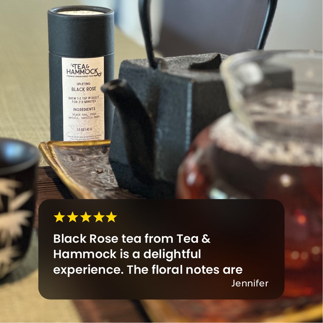 Black Rose tea from Tea & Hammock with a glass teapot and cup on a wooden surface.