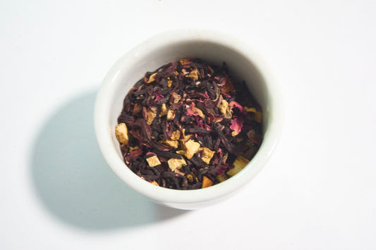 White bowl filled with dried tea leaves on a light background