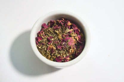 white bowl filled with calming Ayurvedic tea Solace with rose petals chamomile lemon balm holy basil