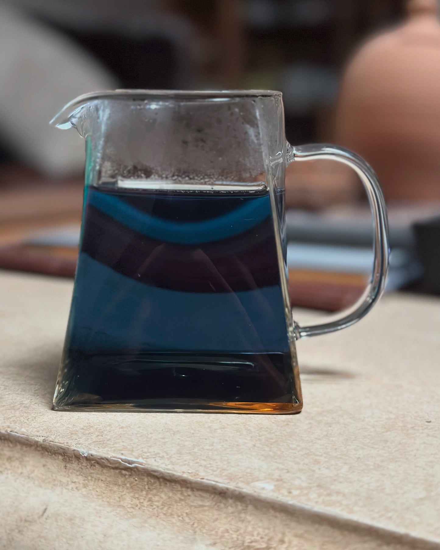 tea & hammock butterfly peaflower tea brewed in clear teapot vibrant color zen background